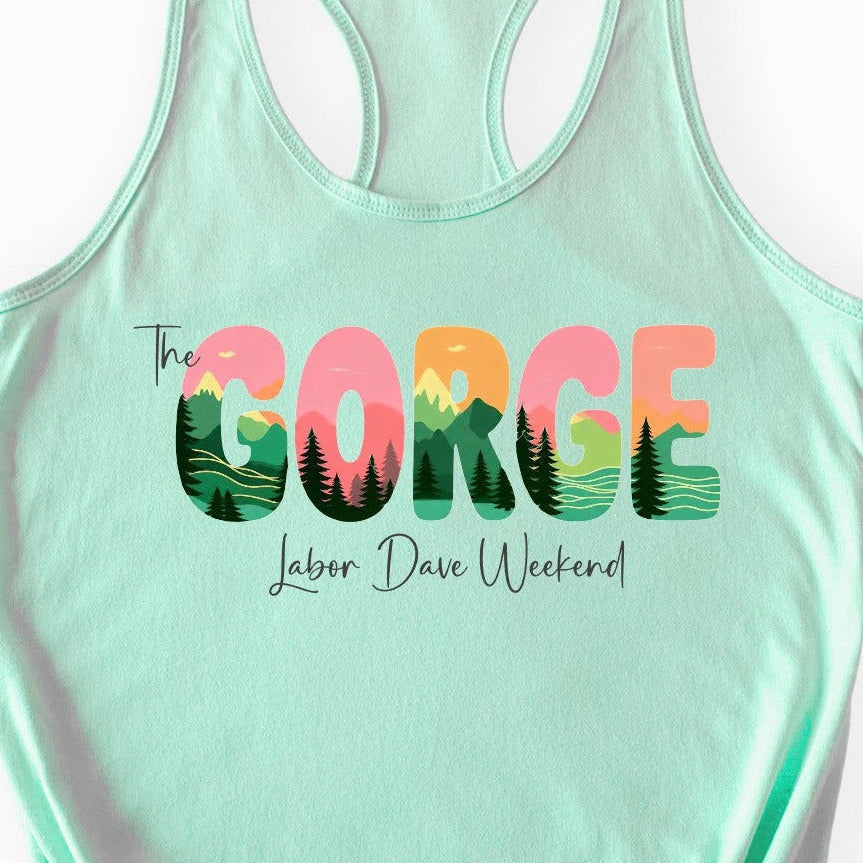 A mint green racerback tank top featuring a colorful graphic on the front that reads 'The GORGE Labor Day Weekend' with a landscape design inside the letters, displayed on a clean white background.